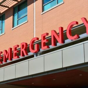 Close-up of a modern hospital emergency room entrance with prominent red letters.