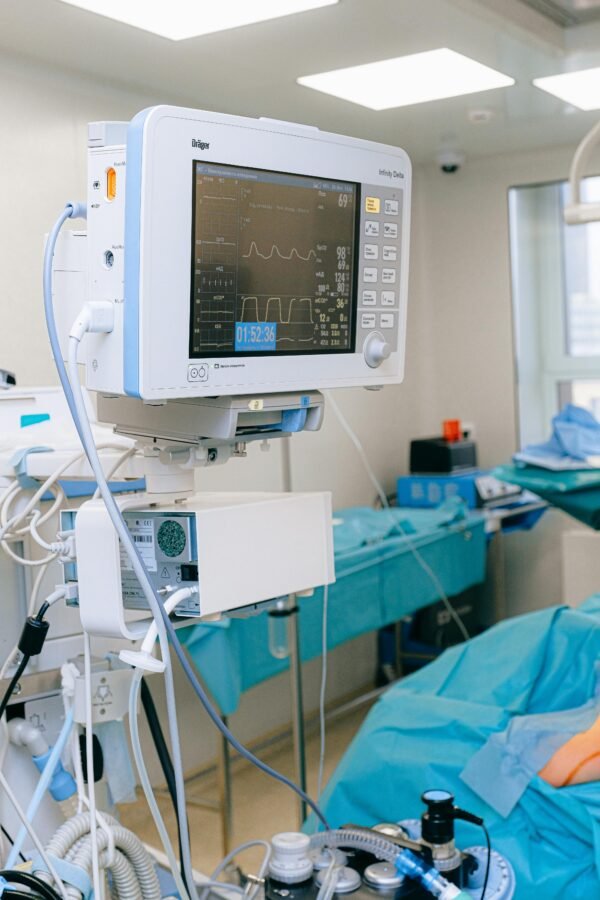 Close-up of vital signs monitor in a modern operating room setup.